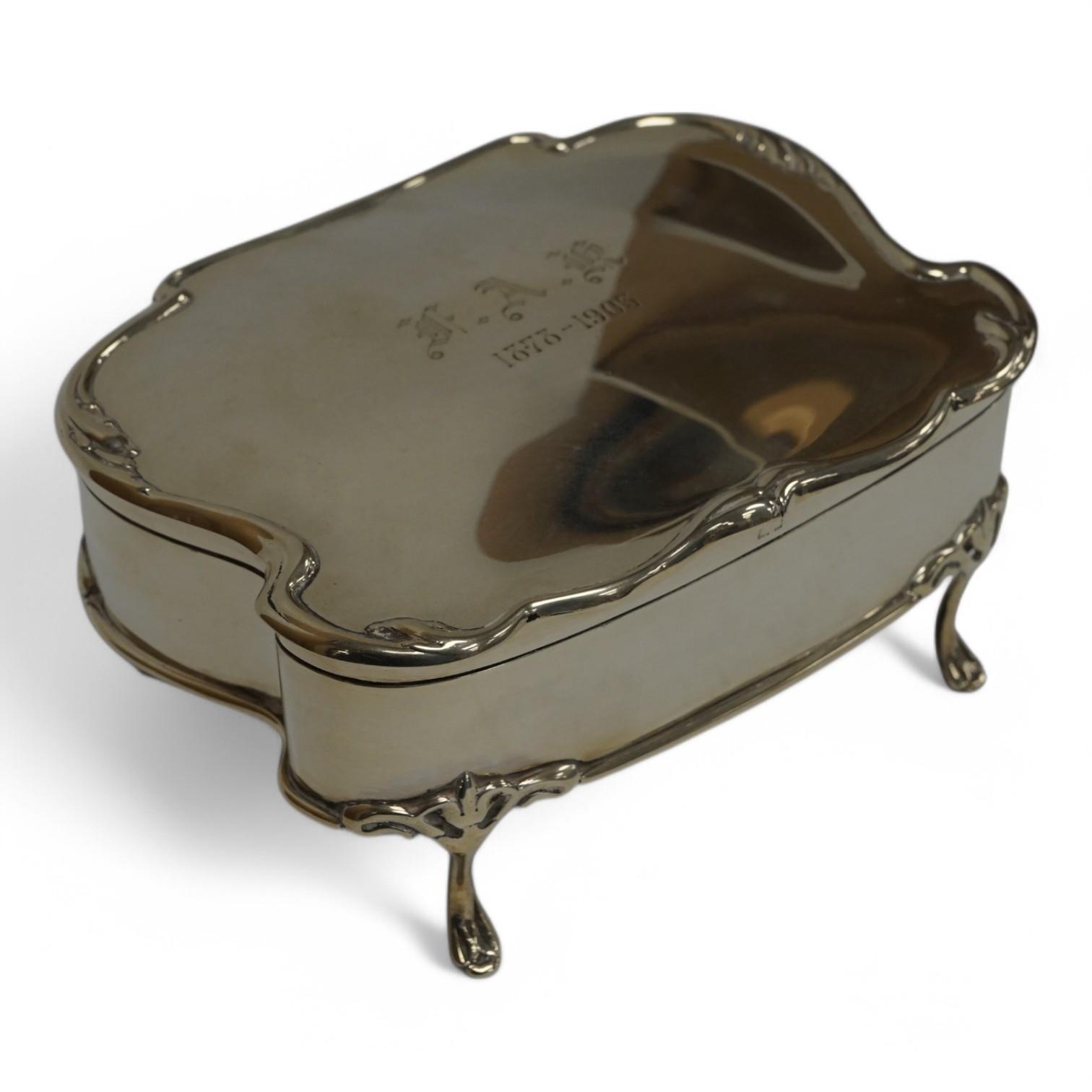 An Edwardian silver shaped rectangular trinket box, with engraved initials and date, on four cabriole legs, Saunders & Shepherd, Birmingham, 1902, (lacking interior), width 16.7cm, 13.2oz. Condition - fair